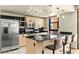 Modern kitchen with stainless steel appliances, black countertops, and bar seating with mountain views at 29 Montelago Blvd # 131, Henderson, NV 89011
