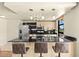 Sleek eat-in kitchen featuring stainless steel appliances, black countertops, and stylish bar seating at 29 Montelago Blvd # 131, Henderson, NV 89011