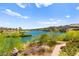 Expansive lake view surrounded by lush greenery and distant mountains, showcasing the property's serene and picturesque location at 29 Montelago Blvd # 131, Henderson, NV 89011