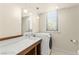 Well-lit laundry room with a sink, mirror, modern washer and dryer, and storage space at 29 Montelago Blvd # 131, Henderson, NV 89011