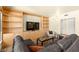 Comfortable living room features custom built-ins, a gray sectional, and a stylish coffee table at 29 Montelago Blvd # 131, Henderson, NV 89011