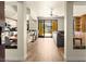 Open-concept living room with hardwood floors, a kitchen, and access to a balcony with scenic views at 29 Montelago Blvd # 131, Henderson, NV 89011