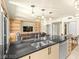 Open-concept living space featuring a kitchen island with a sink and view of living room at 29 Montelago Blvd # 131, Henderson, NV 89011