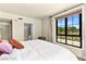 Relaxing bedroom features a comfy king bed, neutral colors and a large window with exterior views at 29 Montelago Blvd # 131, Henderson, NV 89011