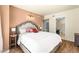 Bright main bedroom features a king bed, modern lighting and a view into the ensuite bathroom at 29 Montelago Blvd # 131, Henderson, NV 89011