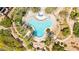 Aerial view of a unique three-leaf clover-shaped pool surrounded by palm trees and lush landscaping at 29 Montelago Blvd # 131, Henderson, NV 89011