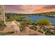 Beautiful waterfront view with vibrant vegetation and a glimpse of elegant properties on the lake at 29 Montelago Blvd # 131, Henderson, NV 89011