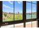 Expansive window captures the picturesque backyard with a pond, lush greenery, and stunning views at 29 Montelago Blvd # 131, Henderson, NV 89011