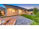 Outdoor space with a patio, lush green lawn, and sleek lounge chairs, creating an ideal space for relaxation and entertainment at 32 Tatahatso Point St, Henderson, NV 89011