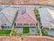 Aerial view of backyard featuring covered patio, artificial turf, privacy wall, and desert landscape at 32 Tatahatso Point St, Henderson, NV 89011
