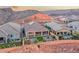 Bird's eye view of backyard featuring covered patio, artificial turf, privacy wall, and desert landscape at 32 Tatahatso Point St, Henderson, NV 89011