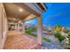 Inviting backyard offers a covered patio with mountain views and cozy seating at 32 Tatahatso Point St, Henderson, NV 89011
