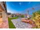 Private backyard features lounge chairs, green space, and beautiful mountain scenery at 32 Tatahatso Point St, Henderson, NV 89011