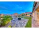 Inviting backyard featuring a cozy fire pit area, perfect for outdoor gatherings and enjoying the peaceful surroundings at 32 Tatahatso Point St, Henderson, NV 89011