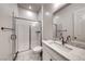 Modern bathroom with a glass-enclosed shower and elegant marble countertop at 32 Tatahatso Point St, Henderson, NV 89011