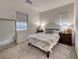 Comfortable bedroom includes a queen bed, cozy decor, and natural light at 32 Tatahatso Point St, Henderson, NV 89011