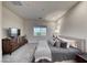 Cozy bedroom featuring plush carpet, modern decor, and a bright window view at 32 Tatahatso Point St, Henderson, NV 89011