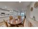 Open-concept dining area with hardwood floors and lots of natural light at 32 Tatahatso Point St, Henderson, NV 89011