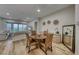 Open dining area featuring hardwood floors, table, and view to living room at 32 Tatahatso Point St, Henderson, NV 89011