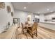 Open dining area showcasing hardwood floors, furniture and view of kitchen at 32 Tatahatso Point St, Henderson, NV 89011