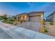 Beautiful single-story home with a tile roof, two-car garage, and desert landscaping in a quiet neighborhood at 32 Tatahatso Point St, Henderson, NV 89011