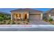 Charming single-story home with a two-car garage, desert landscaping, and a welcoming front porch at 32 Tatahatso Point St, Henderson, NV 89011