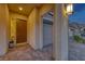 Welcoming front entryway with stylish door, textured walls, and garage access at 32 Tatahatso Point St, Henderson, NV 89011