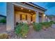 Charming front porch with outdoor seating and well-maintained landscaping at 32 Tatahatso Point St, Henderson, NV 89011