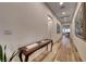 Bright hallway with hardwood floors, decorative console table, and artwork at 32 Tatahatso Point St, Henderson, NV 89011