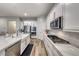 The kitchen features white cabinets and modern appliances at 32 Tatahatso Point St, Henderson, NV 89011