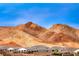 Picturesque mountain backdrop complementing a row of single-Gathering homes in a desert community at 32 Tatahatso Point St, Henderson, NV 89011