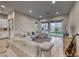 Spacious living room with hardwood floors, comfortable seating, and patio access at 32 Tatahatso Point St, Henderson, NV 89011