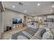 Open-concept living area with hardwood floors, neutral tones, and modern decor at 32 Tatahatso Point St, Henderson, NV 89011