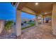 Beautifully designed patio with lush landscaping, providing a serene outdoor living space, complemented with brick pavers at 32 Tatahatso Point St, Henderson, NV 89011