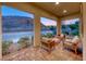 Inviting covered patio featuring comfortable seating and scenic mountain views at 32 Tatahatso Point St, Henderson, NV 89011