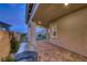 An outdoor patio with a brick floor and an outdoor kitchen, perfect for entertaining guests and enjoying the outdoors at 32 Tatahatso Point St, Henderson, NV 89011