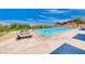 Outdoor pool with lounge chairs and scenic mountain views at 32 Tatahatso Point St, Henderson, NV 89011