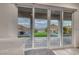 Large sliding doors that showcase the outside patio, pavers, and mountain views at 32 Tatahatso Point St, Henderson, NV 89011