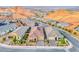 Scenic street view showcasing homes with desert landscaping and mountain views in a vibrant community at 32 Tatahatso Point St, Henderson, NV 89011