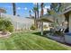 Well-maintained backyard featuring a covered patio, grassy area, and mature landscaping, perfect for outdoor living and entertaining at 3361 Iberia St, Las Vegas, NV 89146