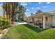 Lush backyard featuring a covered patio, manicured lawn, pool, and vibrant landscaping, ideal for relaxation and outdoor gatherings at 3361 Iberia St, Las Vegas, NV 89146