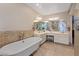 Bright bathroom features a freestanding tub, dual sinks, and tiled accents at 3361 Iberia St, Las Vegas, NV 89146