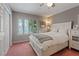 Well-lit bedroom features a queen bed, shuttered windows, and ample storage with a closet and dresser at 3361 Iberia St, Las Vegas, NV 89146