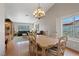Elegant dining area with chandelier, hardwood floors, and access to the living room at 3361 Iberia St, Las Vegas, NV 89146