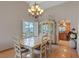 Formal dining area with classic furniture, chandelier, and a view to the kitchen at 3361 Iberia St, Las Vegas, NV 89146