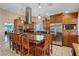 Bright kitchen showcases an island with seating, stainless steel appliances, and tile floors at 3361 Iberia St, Las Vegas, NV 89146