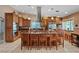 Well-lit kitchen boasts an island with seating, tile flooring, and stainless steel appliances at 3361 Iberia St, Las Vegas, NV 89146
