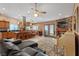 Open-concept living room and kitchen features tile floors, fireplace, and ceiling fan at 3361 Iberia St, Las Vegas, NV 89146