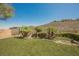 Spacious backyard with a stone waterfall feature, lush grass, and scenic views at 40 Stonemark Dr, Henderson, NV 89052