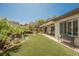 Beautiful backyard with a rock waterfall feature, patio, and well-maintained artificial grass at 40 Stonemark Dr, Henderson, NV 89052